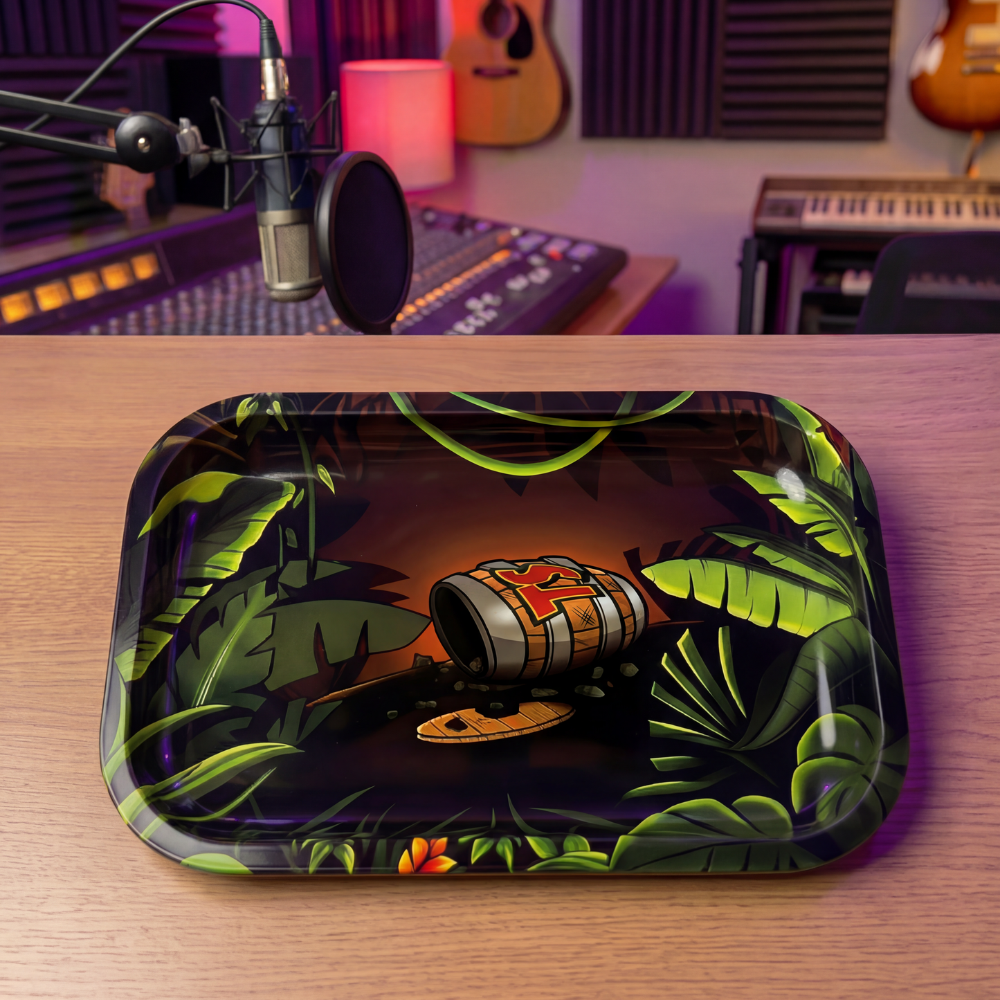Decorative tray with a tropical design on a wooden surface in a music studio setting.